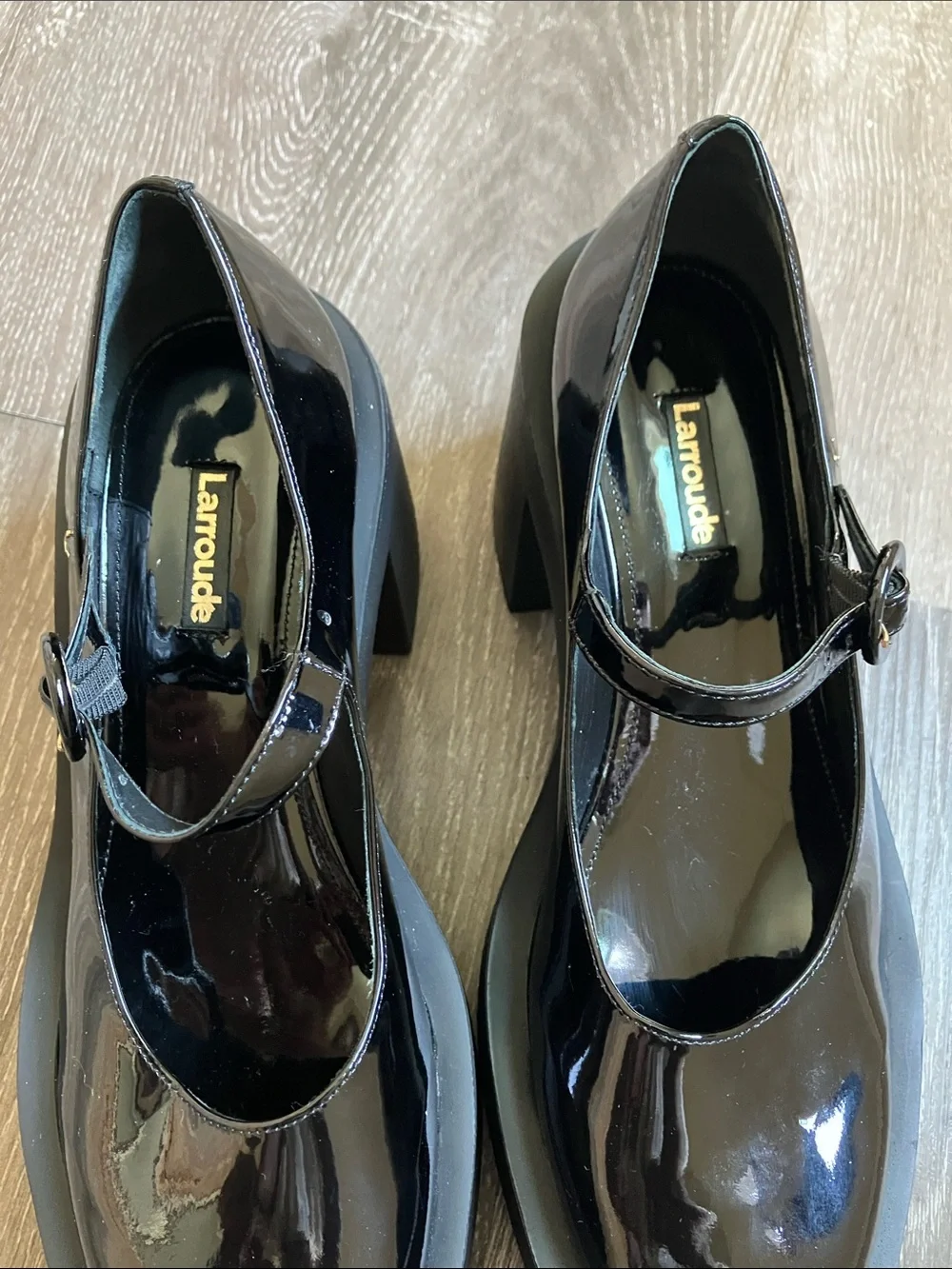 Larroude Olivia Platform Pumps in glossy black patent leather.